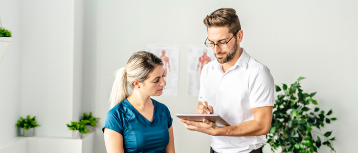chiropractor consulting patient about wellness